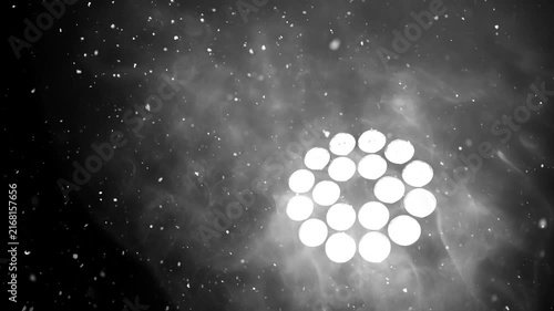 Spotlight shining through smoke and falling snow, creating a dramatic cinematic background. Perfect for winter, Christmas, New Year, stage, concert and festive visual effects.