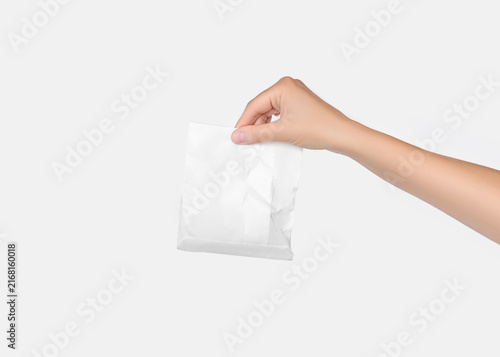 Hand Holding Crumpled White Pouch Packaging Mockup on Neutral Background