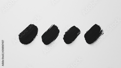 A collection of abstract black ink strokes on a white background.