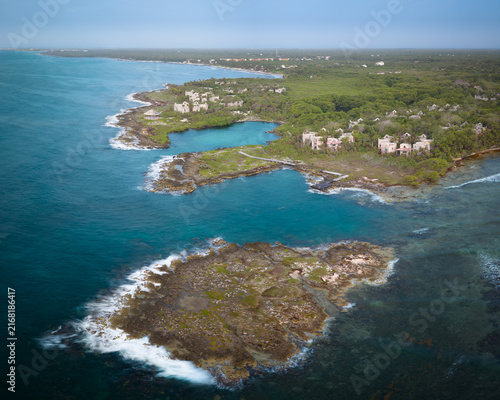 Aerial view of beautiful beach, blue Caribbean sea, luxury resort,wonderful cliff and palm trees surrounded.Summer vacation and travel destination. Playa del Carmen, Riviera Maya, Mexico.
