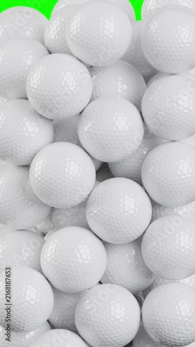 White golf balls falling on green screen background