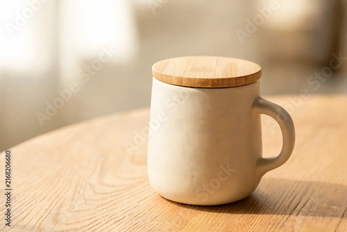 Reusable Ceramic Coffee Cup With Bamboo Lid On Wooden Cafe Table