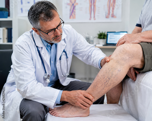 Doctor Examining Elderly Patient's Leg and Knee, Vascular and Geriatric Healthcare