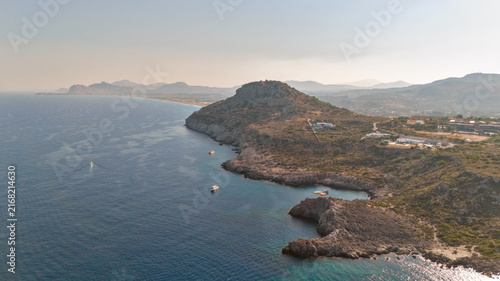 Photography Wide coastal panorama with a green cape and calm silver sea fading into haze