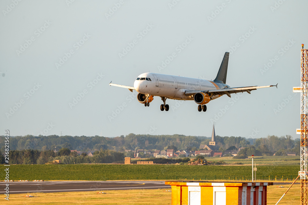 Fototapeta premium Airliner Approaching Over the Runway Fence