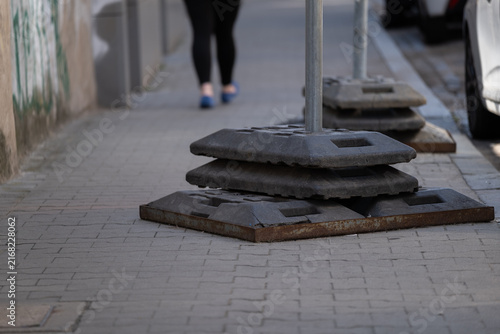 Obraz na płótnie Portable sign base weights installed on sidewalk for temporary traffic managemen