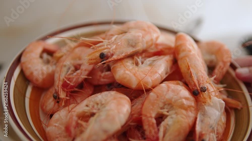 Boiled unpeeled giant shrimp lying on plate after cooking, close up. Red scalded langoustines right after boiling. Natural nutrition with seafood.