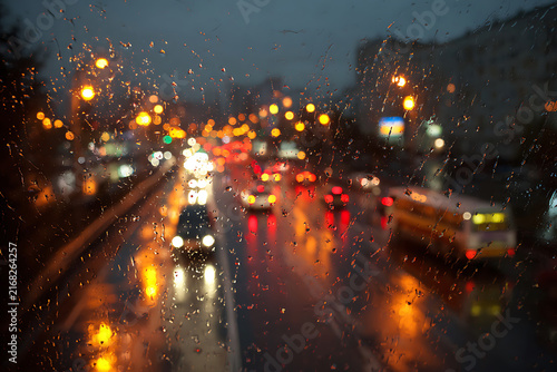 Rainy Night City Traffic with Bokeh Lights and Wet Road Reflections.