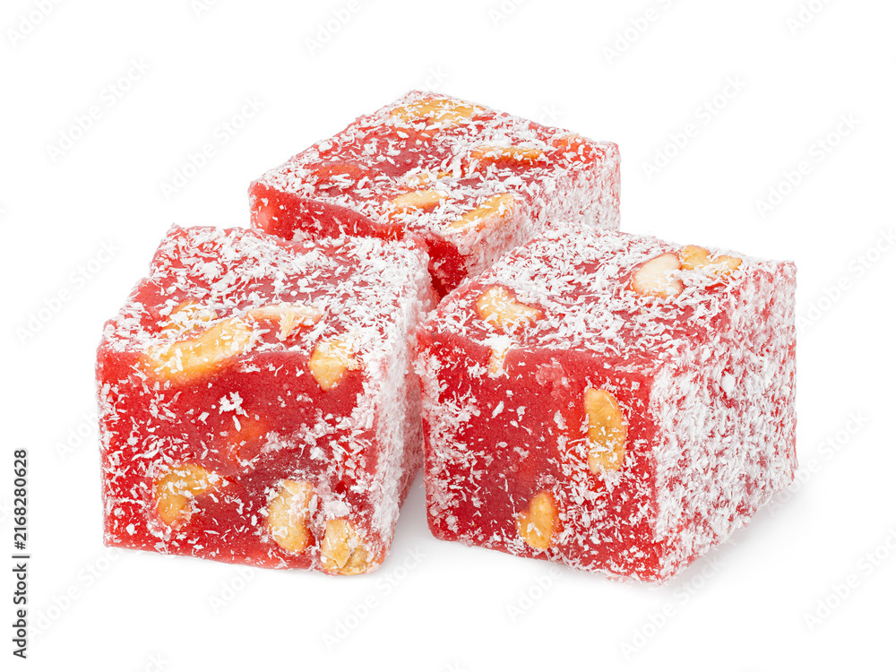 Fototapeta premium Turkish delight cubes with nuts and coconut flakes isolated on white background. Rahat lokum close up. Dessert