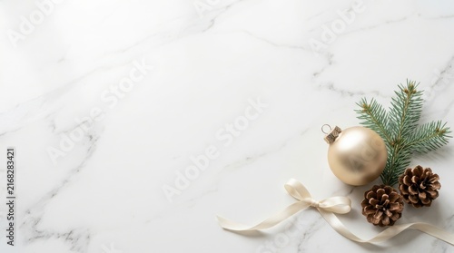 Christmas gold ornament and pine cones on marble background