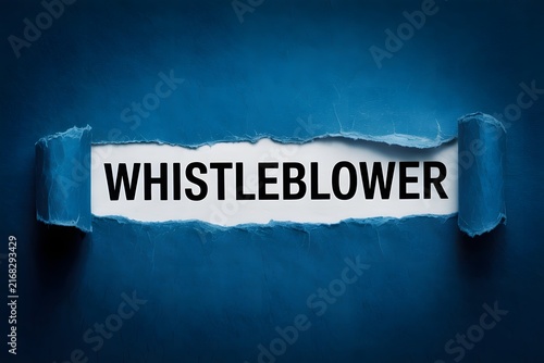 Bold word Whistleblower revealed through torn dark blue textured paper on a white surface