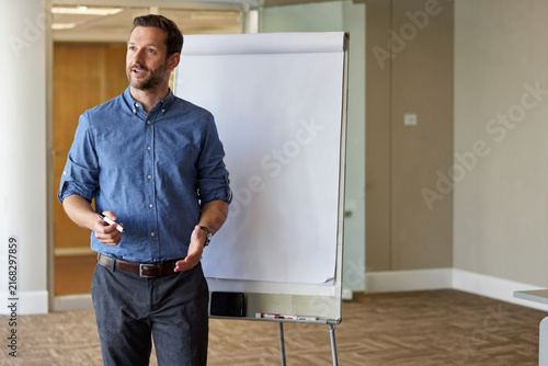 Professional Business Presenter at a Blank Flipchart