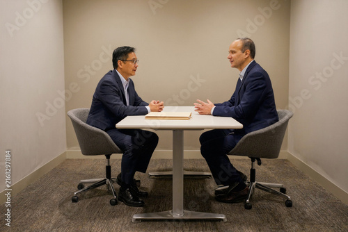 Two Business Leaders Discussing Strategy in a Private Meeting Room