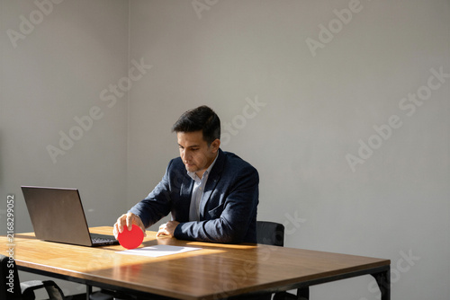 Executive placing a red decision marker on a meeting table