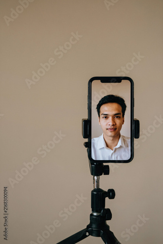 Professional man on smartphone screen in studio