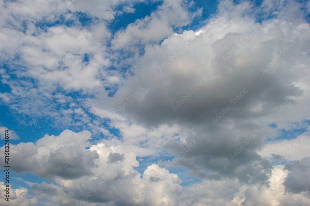Fototapeta premium Clouds in a blue sky in bright sunlight in summer, Voeren, Limburg, Belgium, August, 2026