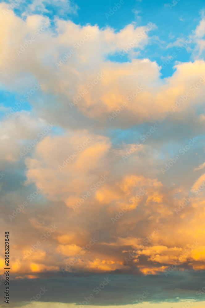 Fototapeta premium Golden evening dramatic sunset sky background - picturesque colorful clouds landscape lit by sunlight