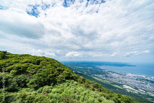 Foto Panoramic aerial view of Beppu city and Beppu bay under blue sky with clouds fro