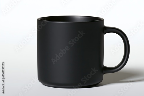 A simple, matte black ceramic mug with a curved handle against a white backdrop