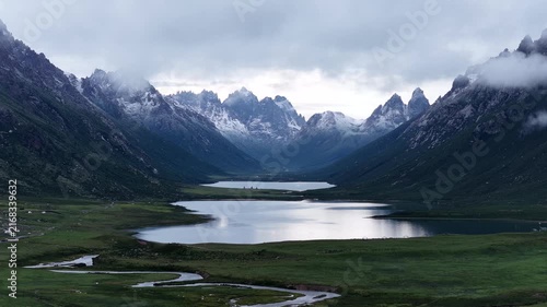 Beautiful green grassland and lake under cloudy sky in the sunset	
