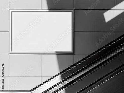 Blank horizontal frame on tiled wall near escalator