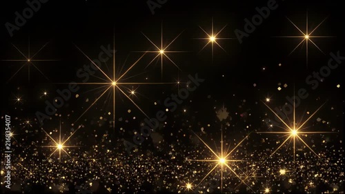 Golden sparkling particles drifting against a dark background with soft light flares for festive celebrations