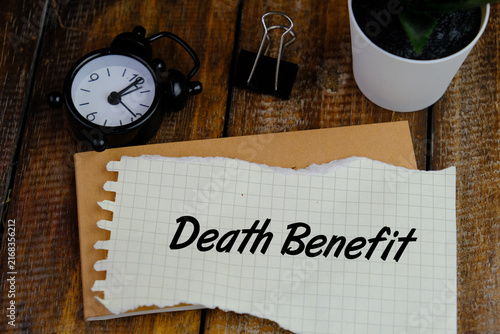 Fotografía Notebook with the words DEATH BENEFIT in the notebook on the background of a bla