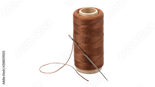 Fotografía Spool of brown sewing thread with metal needle hardware isolated on white backgr