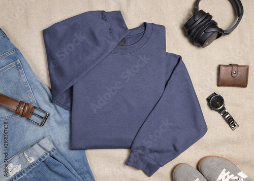 Blank muted blue unisex sweatshirt mockup, folded crewneck with mens accessories and sneakers