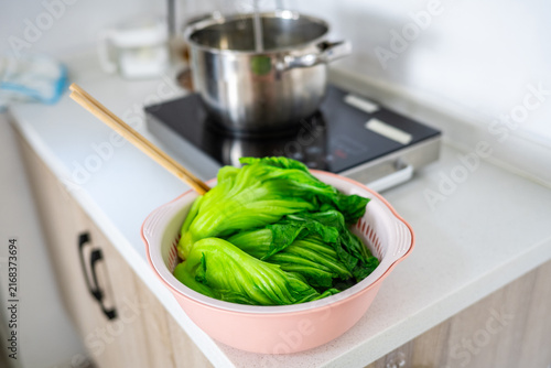 Photography Mustard greens, blanched until half-cooked, in a colander.