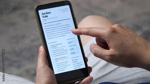 Close-up of a person scrolling a resume on a smartphone, capturing the momentum of mobile hiring, digital careers and modern job search habits in a fast-moving employment market.