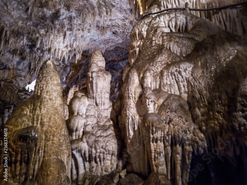 Cuadro en lienzo Massive stalactites and stalagmites formed inside a dark limestone cavern showca