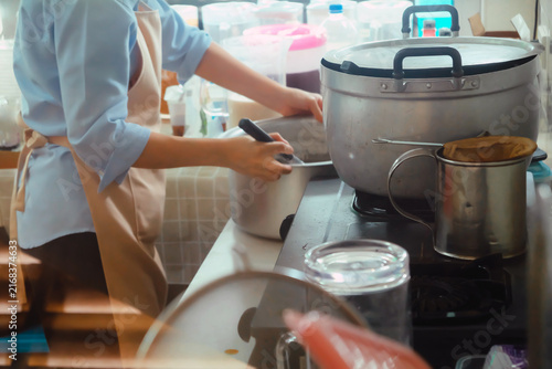 Close up Image of Woman preparing food at the stove