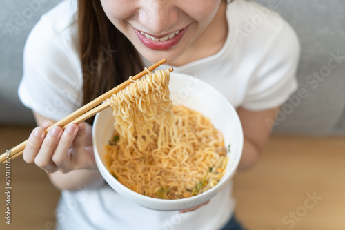Obraz na plátne Close-up people eating instant noodles at home.