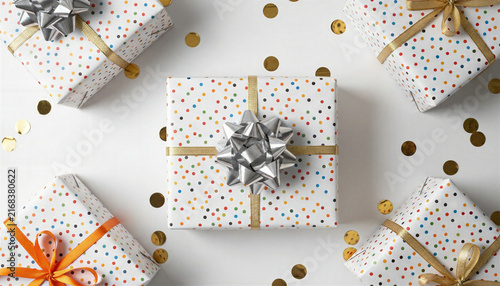 Wrapped gift boxes with confetti on white background