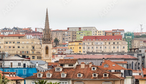 Tower of the Church of the Sacred Heart of Jesus among the rooftops and buildings of the city of Santander, Cantabria, Spain.