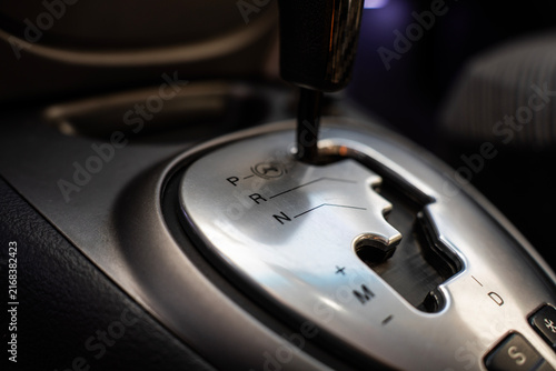 Konstfotografi Automatic transmission gear shift lever on center console of modern car interior, close-up view of silver shifter plate and letters