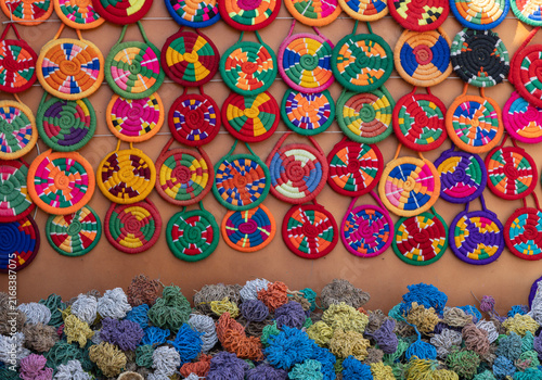 Colorful woven straw plates and dried loofah sponges at Old Market, Sharm El Sheikh, Egypt