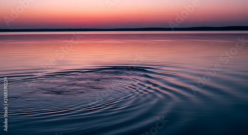 Colorful sunset ripples on calm ocean water, pink and purple sky reflection, serene liquid texture background, tranquil seascape at dusk