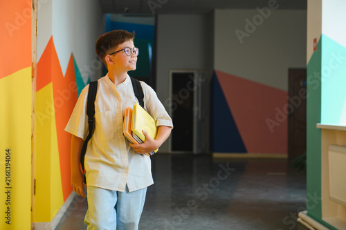 Konstfotografi Student boy walking school corridor carrying books