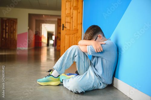 Fotografía Boy hiding face feeling sad from bullying at school