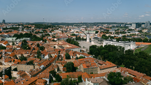 Aerial panorama of Vilnius old town rooftops with a curving street and hazy skyline, lithuania travel content, city tourism marketing, drone photography stock, old town heritage promotion