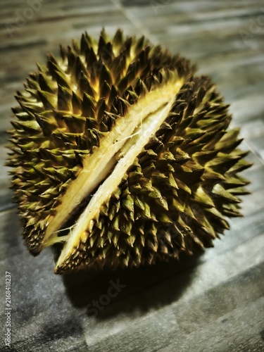 Photography Cracked Ripe Whole Durian Fruit with Spiky Thorns Husk on Rustic Table, King of
