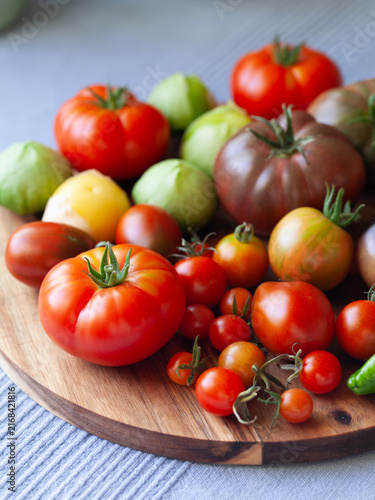 Canvas Print Tomato and tomatillo vegetable  -  a garden harvest of gourmet varieties of heirloom tomatoes, Solanum lycopersicum -  includes black, cherry, plum, oxheart and beefsteak delicious berries
