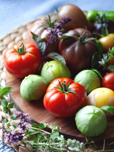 Tomato and tomatillo vegetable  -  a garden harvest of gourmet varieties of heirloom tomatoes, Solanum lycopersicum -  includes black, cherry, plum, oxheart and beefsteak delicious berries.