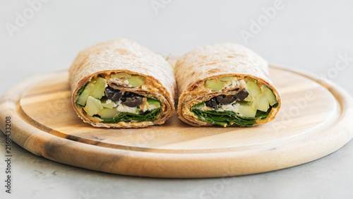 Healthy Vegetable Wrap with Cucumbers, Olives, Spinach, and Feta Cheese Close Up