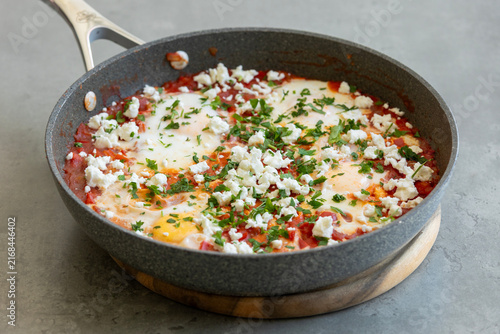 Fotografie Traditional Middle Eastern Shakshuka with Poached Eggs, Tomatoes, and Feta Chees