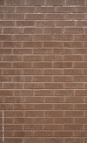 Cuadro en lienzo A close‑up view of a terra cotta painted brick wall with rough grooved brick fac