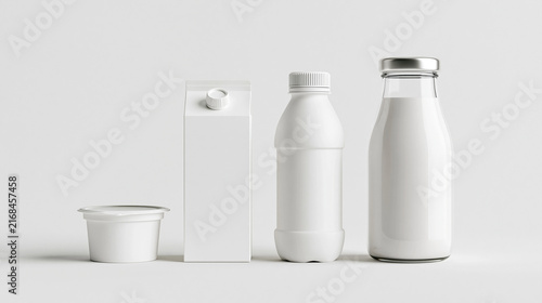 A blank white dairy packaging mockup set including a milk carton, glass bottle, plastic bottle, and yogurt cup isolated on a neutral studio background.