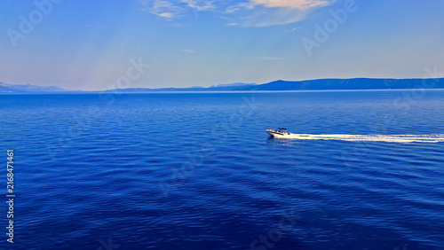 Cuadro en lienzo A motorboat glides over the calm, blue waters of the adriatic sea, offering a perfect escape for summer travel
